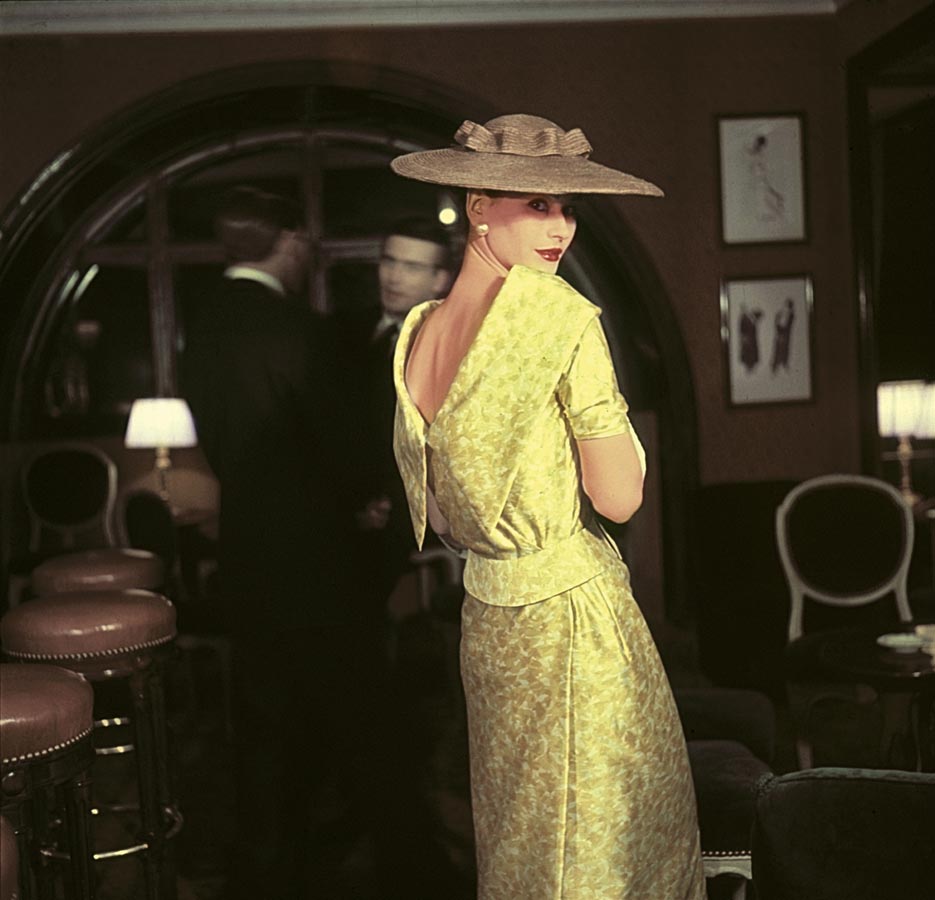 Photographie inédite prise chez Maxim's, femme portant un ensemble jaune décolleté dans le dos de Lanvin Castillo.